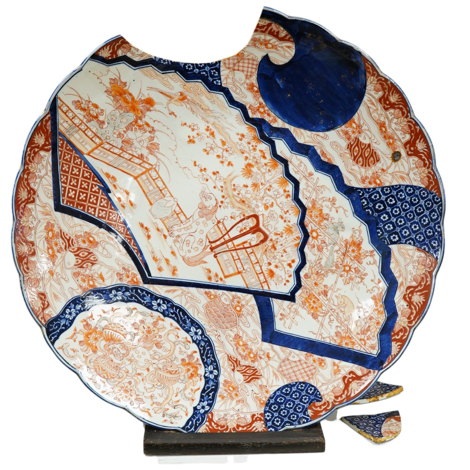 A large 19th century Japanese Imari charger on stand, 61cm in diameter. Condition - poor